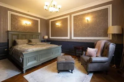 a bedroom with a bed and a chair at Downtown Residence in Podgorica