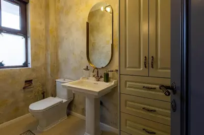 a bathroom with a sink and a toilet and a mirror at Downtown Residence in Podgorica