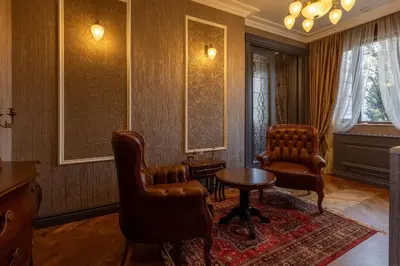 a living room with two chairs and a table at Downtown Residence in Podgorica