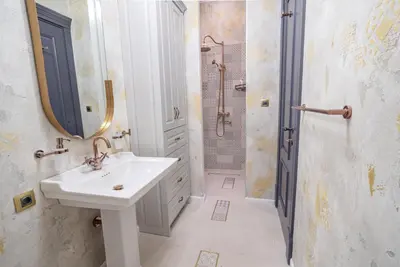 a white bathroom with a sink and a shower at Downtown Residence in Podgorica