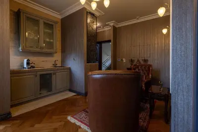 a living room with a kitchen with a couch in it at Downtown Residence in Podgorica