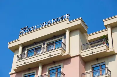 a hotel with a sign on top of a building at Hotel Vladimir in Budva
