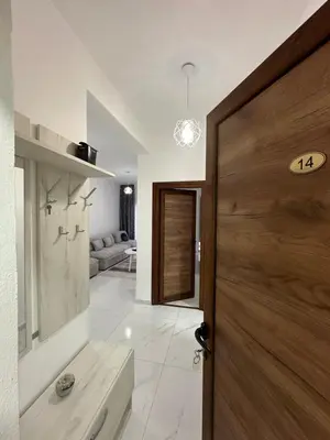 a hallway with a door and a living room at Apartments Amar in Ulcinj