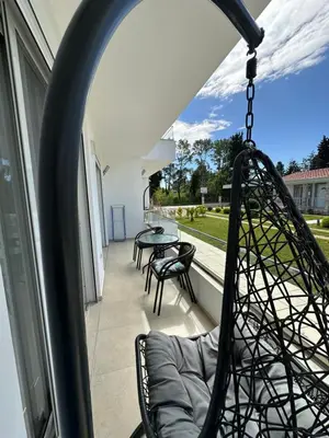 a swing on the balcony of a house at Apartments Amar in Ulcinj