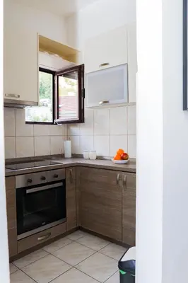 a kitchen with a sink and a stove top oven at 3-Bedroom Apartment With Panoramic Bay Views in Kotor