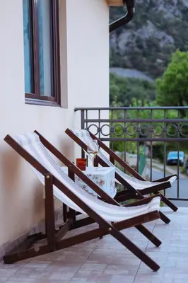 a pair of lounge chairs sitting on a balcony at 3-Bedroom Apartment With Panoramic Bay Views in Kotor