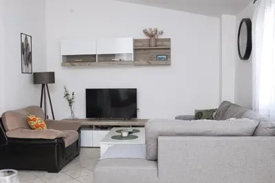 a living room with two couches and a flat screen tv at 3-Bedroom Apartment With Panoramic Bay Views in Kotor