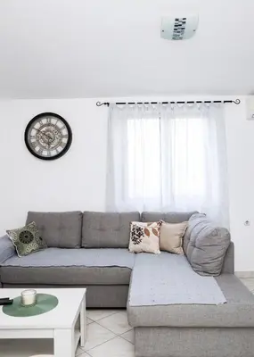 a living room with a couch and a table at 3-Bedroom Apartment With Panoramic Bay Views in Kotor