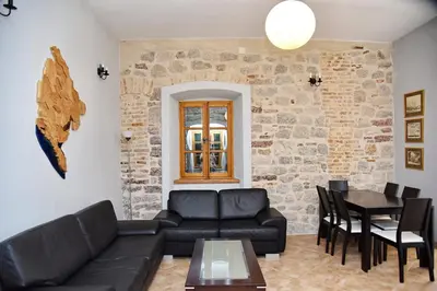 a living room with a couch and a table at Cozy 2 Bedroom Apartment in Antique Bizanti Palace in Kotor