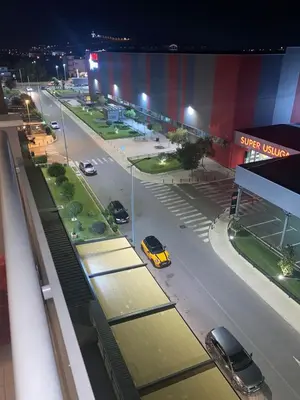 a view of a city street at night with cars parked at Adrianna apartment City kvart in Podgorica