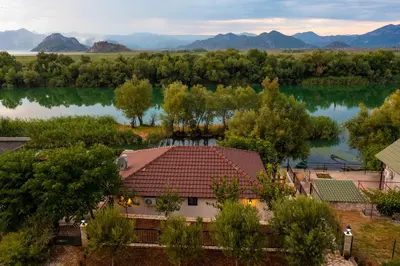 an aerial view of a house with a lake at Lotos Luxury House - Skadar Lake in Virpazar