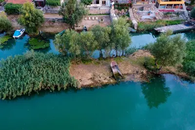 an aerial view of an island in the water at Lotos Luxury House - Skadar Lake in Virpazar