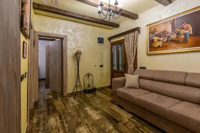 a living room with a couch and a painting on the wall at Lotos Luxury House - Skadar Lake in Virpazar