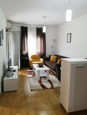a living room with a couch and a table at Flat Iva in Podgorica