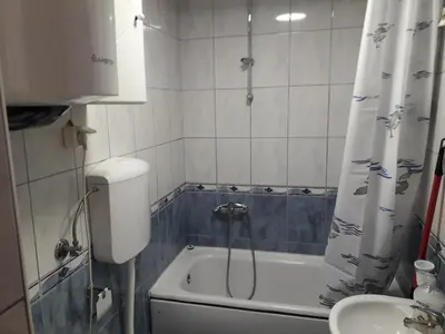 a bathroom with a tub and a shower and a sink at Flat Iva in Podgorica