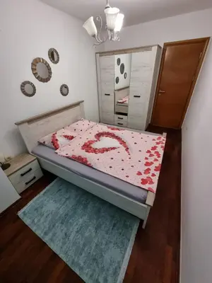 a small bedroom with a bed and a dresser at 5 star apartment in Podgorica