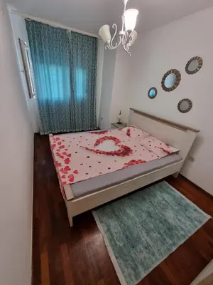 a small bedroom with a bed and a window at 5 star apartment in Podgorica