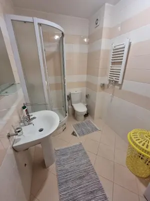 a bathroom with a sink and a shower and a toilet at 5 star apartment in Podgorica
