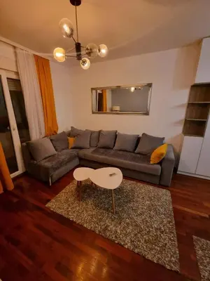 a living room with a couch and a table at 5 star apartment in Podgorica