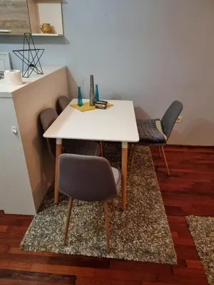 a white table and chairs in a room at 5 star apartment in Podgorica