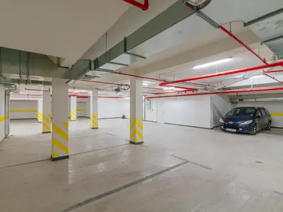 a parking garage with a car parked in it at Hotel New Star in Podgorica