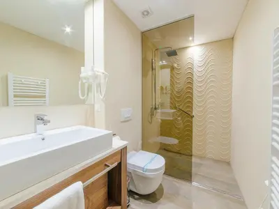 a bathroom with a sink and a toilet and a shower at Hotel New Star in Podgorica
