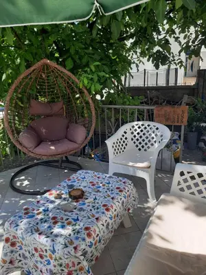 a chair and a table with a blanket on a patio at Милый гостевой апартамент in Bar