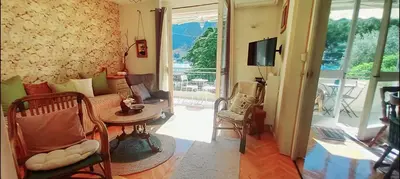 a living room with a couch and a table at Apartment Navigator's lodging in Kotor