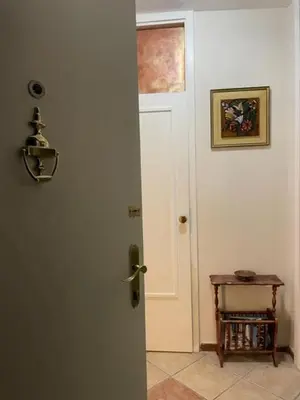 a door in a room with a table next to it at Apartment Navigator's lodging in Kotor