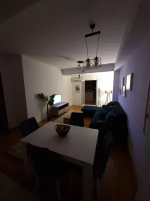 a living room with a table and a couch at Big apartment in Podgorica