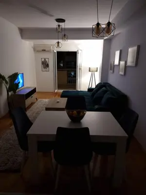 a living room with a table and a couch at Big apartment in Podgorica