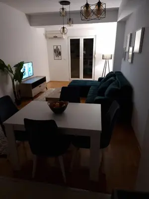 a living room with a table and a couch at Big apartment in Podgorica