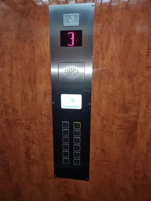 a remote control sitting on top of a wooden table at Big apartment in Podgorica