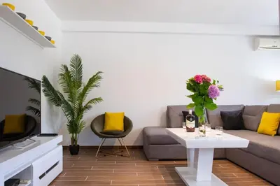 a living room with a couch and a table at Campi d’Oro in Kotor