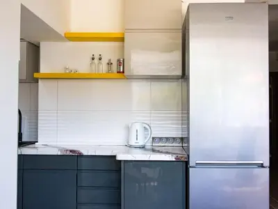 a kitchen with stainless steel appliances and white walls at Campi d’Oro in Kotor