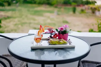 a table with a plate of food on it at Flori Apartments in Ulcinj