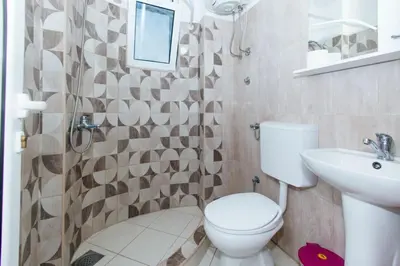 a bathroom with a toilet and a sink at Flori Apartments in Ulcinj