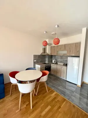 a kitchen and dining room with a table and chairs at Z apartment in Podgorica