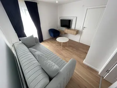 a living room with a couch and a table at Lungomare Apartments in Petrovac na Moru
