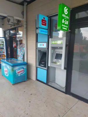 an atm machine in a store with a trashcan next to it at Oscar in Podgorica