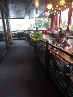 a man sitting at a table in a restaurant at Oscar in Podgorica