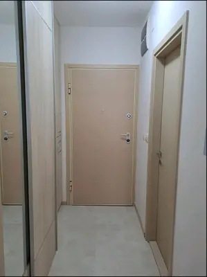 a hallway with a door in a room at Apartman City kvart in Podgorica