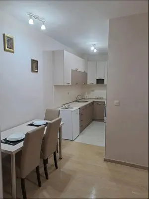 a kitchen and dining room with a table and chairs at Apartman City kvart in Podgorica