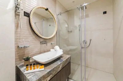 a bathroom with a sink and a shower at Hotel Aurel Coast in Kotor