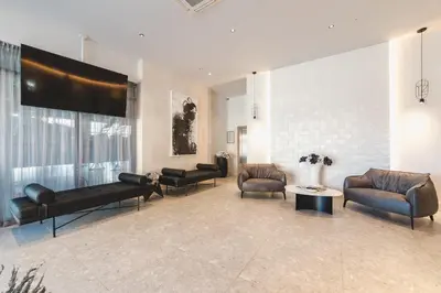 a lobby with couches and chairs and a large screen at Hotel Aurel Coast in Kotor