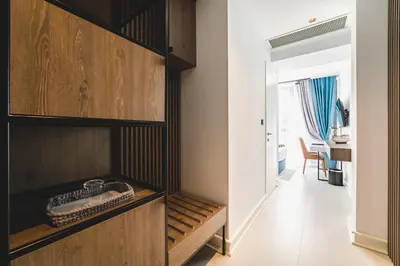 a room with a wooden cabinet and a hallway at Hotel Aurel Coast in Kotor