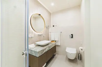 a bathroom with a sink and a toilet and a mirror at Hotel Aurel Coast in Kotor