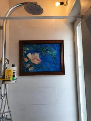 a painting hanging on a wall in a bathroom at Stone house Djakonovic in Budva
