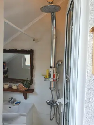 a bathroom with a sink and a mirror at Stone house Djakonovic in Budva