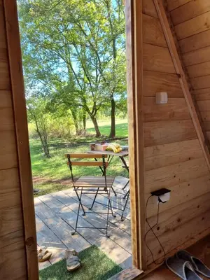 a door leading to a patio with a table in a cabin at Private Camp - Wolf & Sheep - 4 bungalows- 8 person in Podgorica
